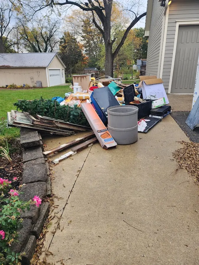 Dumpster being loaded with debris for Roofing Dumpster Rental in Sumpter